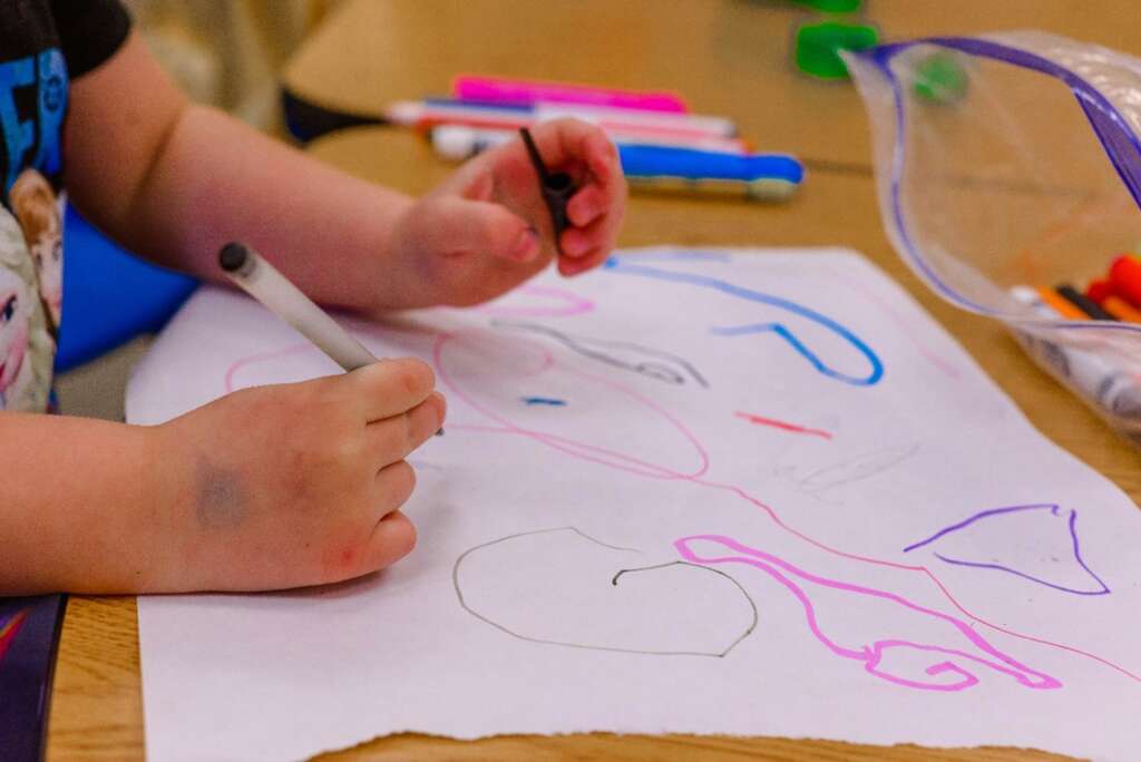 A child drawing on a piece of paper