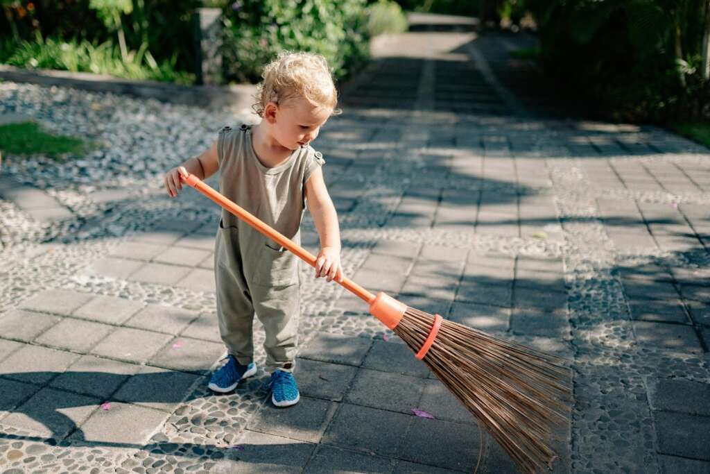 A child holding a broom