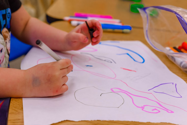 A child drawing on a paper