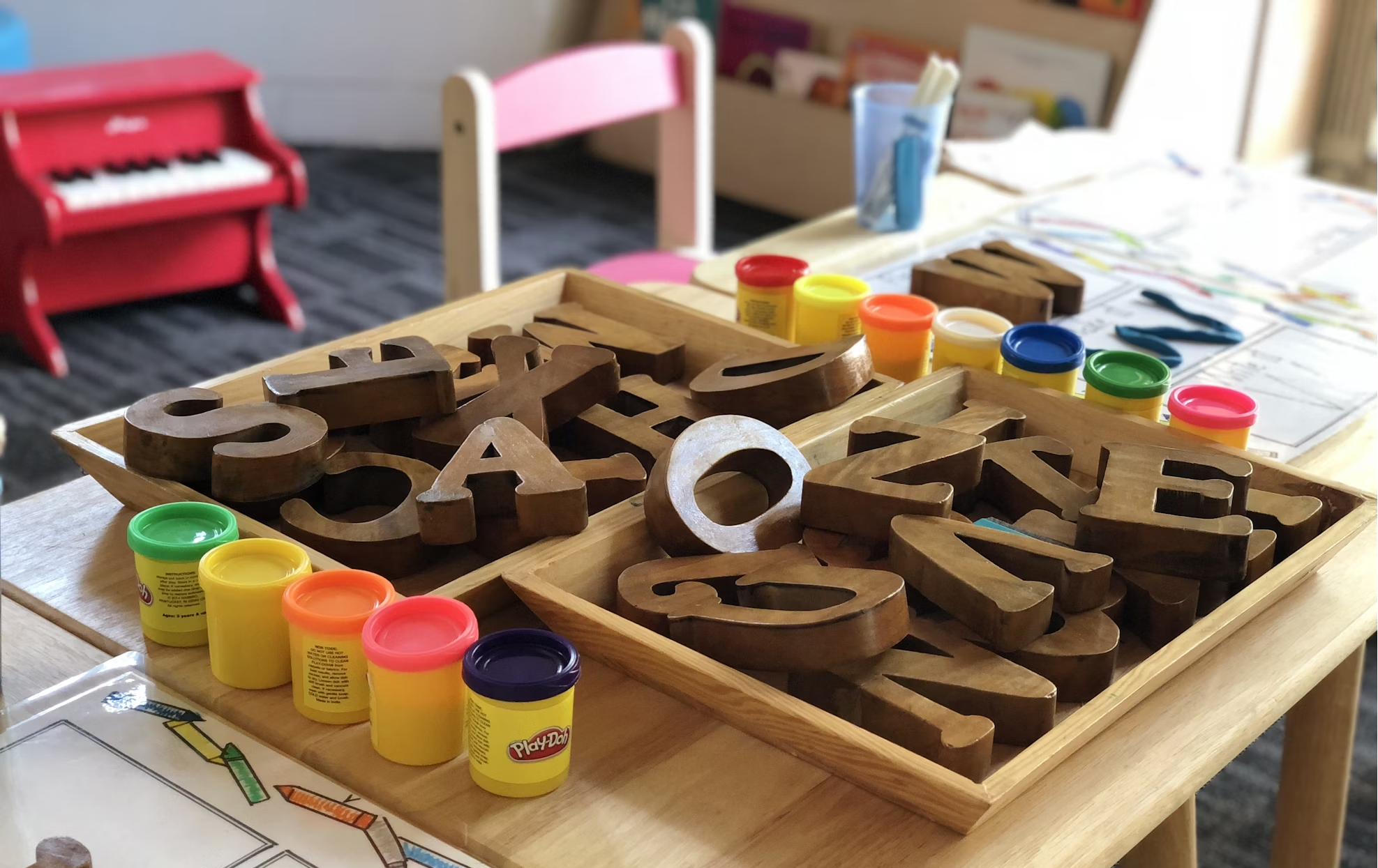 Wooden alphabets in a tray with some paint